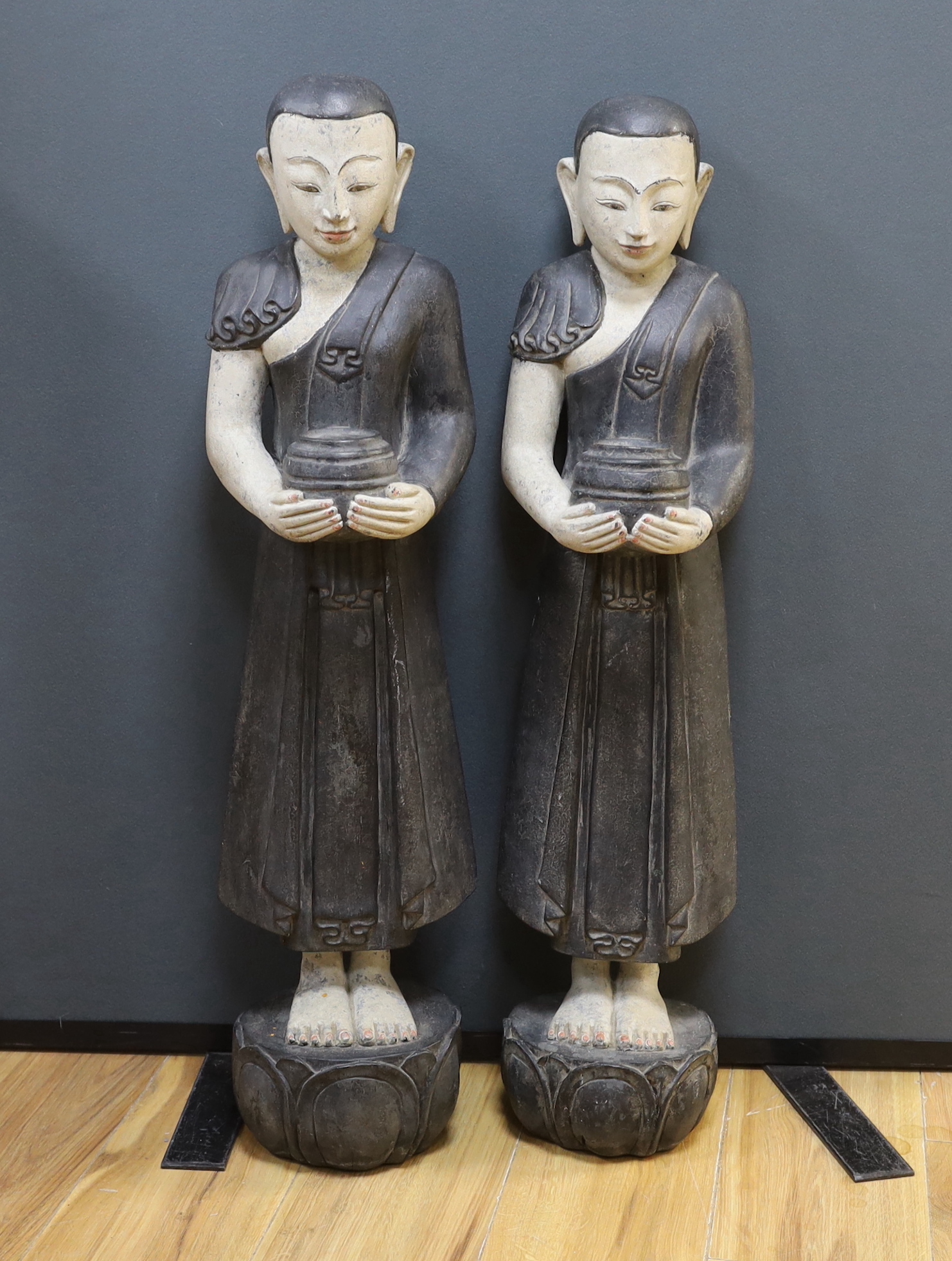 A pair of floor standing Thai figures, 80cm high